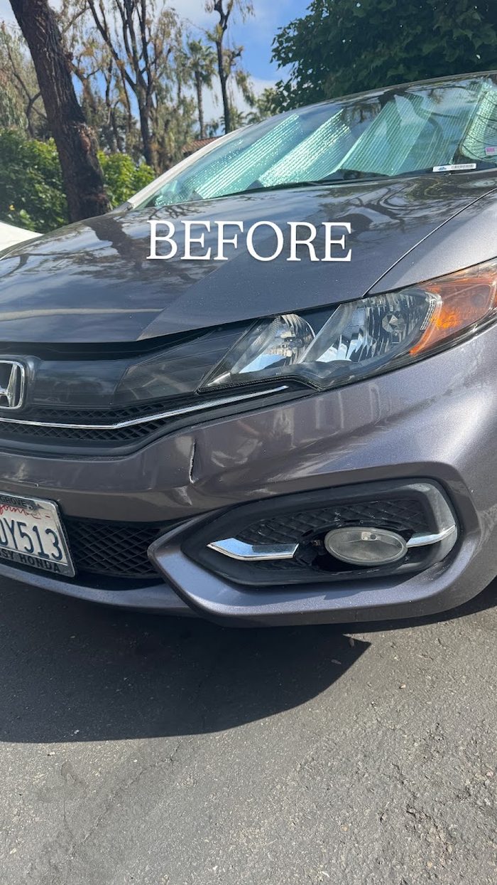 Damaged front bumper on a gray Honda